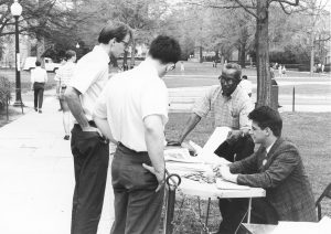 Labor leader Oliver Harvey (center) and an unnamed student distribute Local 77 literature on Duke campus, April 1967 (Duke University Archives)